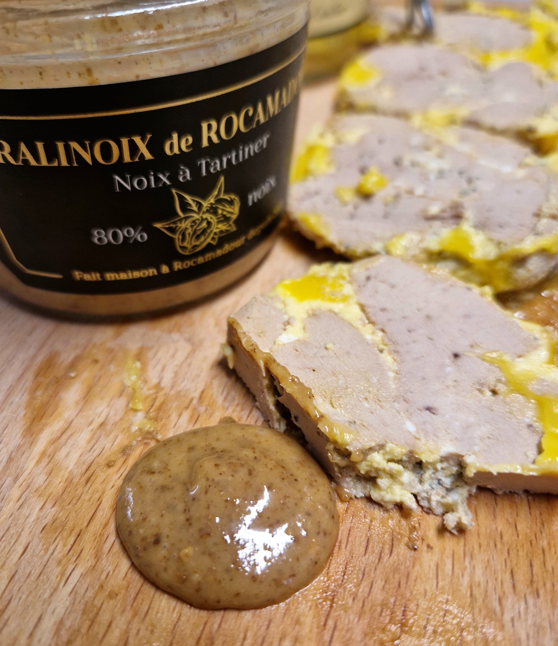 Pralinoix de Rocamadour paired with foie gras on a rustic wooden board
